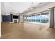 Expansive living room with contemporary lighting and large windows overlooking a luxurious pool at 8840 Harvest Sunset St, Las Vegas, NV 89113