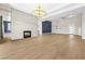Spacious living room with fireplace, statement lighting, and tile flooring at 8840 Harvest Sunset St, Las Vegas, NV 89113