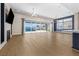 Bright living room with stylish flooring, modern fireplace, and pool view at 8840 Harvest Sunset St, Las Vegas, NV 89113