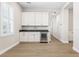 Bright living room with white cabinets, gray countertops, and a wine refrigerator at 8840 Harvest Sunset St, Las Vegas, NV 89113