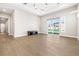 Open living space features wood floors, modern lighting, and backyard access at 8840 Harvest Sunset St, Las Vegas, NV 89113