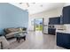 Open-concept living room with wood-look flooring and a view of the backyard at 8840 Harvest Sunset St, Las Vegas, NV 89113