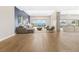 Spacious living room with modern decor, hardwood floors, and an open layout, virtually staged at 8840 Harvest Sunset St, Las Vegas, NV 89113