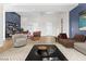 Staged living room offering designer furnishings, wood-look floors, and a modern aesthetic at 8840 Harvest Sunset St, Las Vegas, NV 89113
