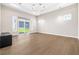 Bright living room with modern light fixture and sliding glass doors to backyard at 8840 Harvest Sunset St, Las Vegas, NV 89113