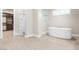 A bright primary bathroom featuring a soaking tub, walk-in shower and neutral design at 8840 Harvest Sunset St, Las Vegas, NV 89113