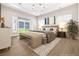 Staged main bedroom features modern lighting, neutral tones, and a view of the backyard at 8840 Harvest Sunset St, Las Vegas, NV 89113