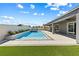 Relaxing pool featuring a jacuzzi, a tanning ledge, and lush artificial turf at 8840 Harvest Sunset St, Las Vegas, NV 89113