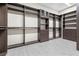 Spacious walk-in closet with custom shelving, drawers, and tile floors at 8840 Harvest Sunset St, Las Vegas, NV 89113