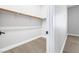 Simple walk-in closet with a rod for hanging clothes and wood-look floors at 8840 Harvest Sunset St, Las Vegas, NV 89113