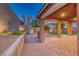 Covered patio featuring a built-in BBQ area, brick pavers, and desert landscaping at 928 Riverlawn Pl, Las Vegas, NV 89138