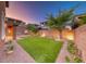 A backyard featuring artificial turf, desert landscaping, and a perimeter wall at 928 Riverlawn Pl, Las Vegas, NV 89138