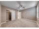 Bedroom featuring neutral carpet, ceiling fan and bright shutters at 928 Riverlawn Pl, Las Vegas, NV 89138