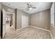 Bedroom with a ceiling fan, access to a closet, and a view into the hallway at 928 Riverlawn Pl, Las Vegas, NV 89138