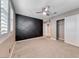 Bedroom featuring an accent wall, ceiling fan, neutral carpet and bright shutters at 928 Riverlawn Pl, Las Vegas, NV 89138