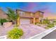 Attractive two-story home with brick paved driveway and desert landscaping at 928 Riverlawn Pl, Las Vegas, NV 89138