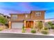 Charming two-story home boasts a well-manicured front yard, brick-paved driveway, and a welcoming entrance at 928 Riverlawn Pl, Las Vegas, NV 89138
