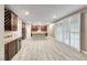 Bright, open kitchen with an island, custom cabinets, and stainless steel appliances, leading into a large area with plantation shutters at 928 Riverlawn Pl, Las Vegas, NV 89138
