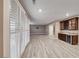 Spacious living area featuring lots of natural light, with tile floors, and leading to a bar area with wine fridge at 928 Riverlawn Pl, Las Vegas, NV 89138