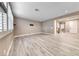Empty living room with wood floors, plantation shutters, and view of foyer and stairs at 928 Riverlawn Pl, Las Vegas, NV 89138