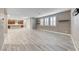 Spacious living area with wood floors, plantation shutters, and access to kitchen and dining at 928 Riverlawn Pl, Las Vegas, NV 89138