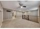Spacious loft with neutral carpeting, a ceiling fan, and large windows providing ample natural light at 928 Riverlawn Pl, Las Vegas, NV 89138