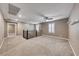 A loft area with neutral carpeting, a ceiling fan, and large windows with shutters, providing an open space at 928 Riverlawn Pl, Las Vegas, NV 89138