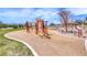 Community playground with various play structures, landscaping and shaded benches at 928 Riverlawn Pl, Las Vegas, NV 89138