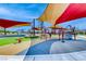 Colorful community playground with sunshades and various play structures for children to enjoy at 928 Riverlawn Pl, Las Vegas, NV 89138
