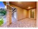 Covered portico with brick pavers and tiled pillars leading to the front door at 928 Riverlawn Pl, Las Vegas, NV 89138