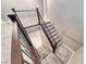 Looking down on carpeted stairs with dark wood and modern metal railing and a glimpse of the hardwood landing at 928 Riverlawn Pl, Las Vegas, NV 89138