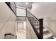 A staircase with carpeted steps, a wood handrail, and decorative metal balusters leads to the upper level at 928 Riverlawn Pl, Las Vegas, NV 89138