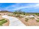 Neighborhood walking path, with native vegetation and views of the community at 928 Riverlawn Pl, Las Vegas, NV 89138
