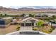 Expansive aerial view of a well-maintained property featuring a large driveway and desert landscaping at 10470 Irish Cliffs Ct, Las Vegas, NV 89149