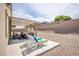 Covered back patio features lounge seating, sleek furniture and shade from the bright, sunny backyard at 10470 Irish Cliffs Ct, Las Vegas, NV 89149