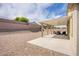 Open backyard features patio with furniture, gravel, and a retaining wall in a low maintenance setting at 10470 Irish Cliffs Ct, Las Vegas, NV 89149