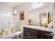 Well-lit bathroom featuring a glass-enclosed shower, granite countertop, and decorative accents at 10470 Irish Cliffs Ct, Las Vegas, NV 89149