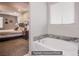 Bathroom featuring a luxurious soaking tub next to a bedroom at 10470 Irish Cliffs Ct, Las Vegas, NV 89149