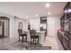 Open-concept kitchen featuring a granite island with bar seating and stainless steel appliances at 10470 Irish Cliffs Ct, Las Vegas, NV 89149