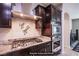 Gourmet kitchen featuring stainless steel appliances, granite countertops, and ample cabinet space for storage at 10470 Irish Cliffs Ct, Las Vegas, NV 89149