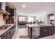 Open-concept kitchen featuring granite countertops, stainless steel appliances, and a view to the living area at 10470 Irish Cliffs Ct, Las Vegas, NV 89149