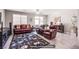 Cozy living room with comfortable seating, area rug, and sliding glass doors for natural light at 10470 Irish Cliffs Ct, Las Vegas, NV 89149