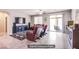 Bright living room with tile floors, stylish furnishings, and access to the outdoor patio at 10470 Irish Cliffs Ct, Las Vegas, NV 89149