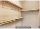 Walk-in closet equipped with wooden shelves for optimal storage and organization at 10470 Irish Cliffs Ct, Las Vegas, NV 89149