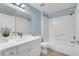 Bright bathroom with a bathtub and a white vanity with sink at 10553 Pine Glen Ave # 101, Las Vegas, NV 89144