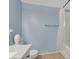 Cozy bathroom featuring blue walls, decorative accents, and a tub with shower at 10553 Pine Glen Ave # 101, Las Vegas, NV 89144