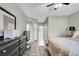 Bright bedroom featuring wood floors, ceiling fan, and stylish dark dresser at 10553 Pine Glen Ave # 101, Las Vegas, NV 89144