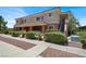 Exterior view of a two-story condo featuring a covered porch and well-maintained landscaping at 10553 Pine Glen Ave # 101, Las Vegas, NV 89144