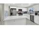Bright kitchen with white cabinets, stainless steel appliances, and a breakfast bar at 10553 Pine Glen Ave # 101, Las Vegas, NV 89144