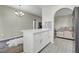 Kitchen island with white cabinets and countertop, tile floors, and access to the living room at 10553 Pine Glen Ave # 101, Las Vegas, NV 89144